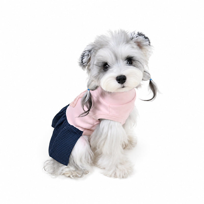 Side profile of small dog wearing pink preppy turtleneck dress