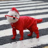 Pink dog raincoat with built-in rain boots on small white dog