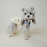 Cream waffle-knit dog vest with blue plaid bandana collar and bunny patch, flat lay