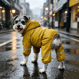 Miniature schnauzer wearing green fleece-lined hooded raincoat outdoors in the rain