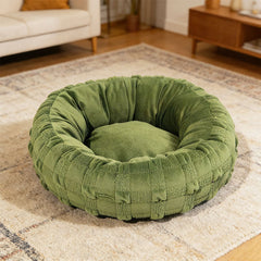Yorkshire terrier resting in grey woven donut dog bed
