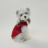 Small dog wearing red fleece vest showing back detail and cute embroidered leather patch